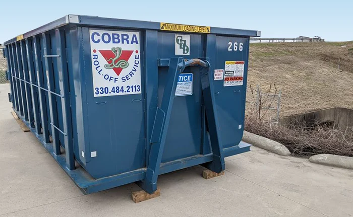 A Cobra Roll Off dumpster wating to be delivered