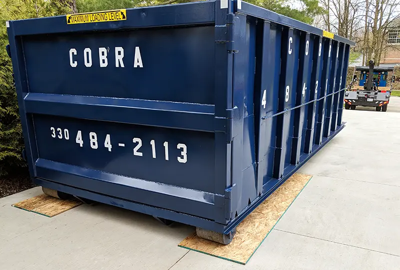 25 yard roll-off dumpster placed in a driveway